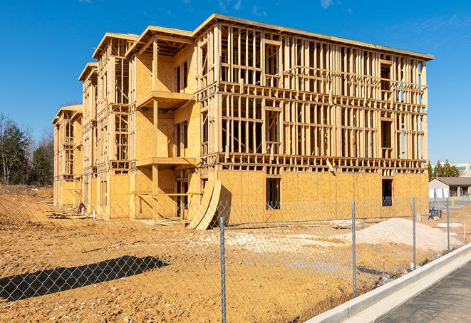 a close-up of temporary chain link fences enclosing a construction site, signaling progress in the project's development in Sheffield AL